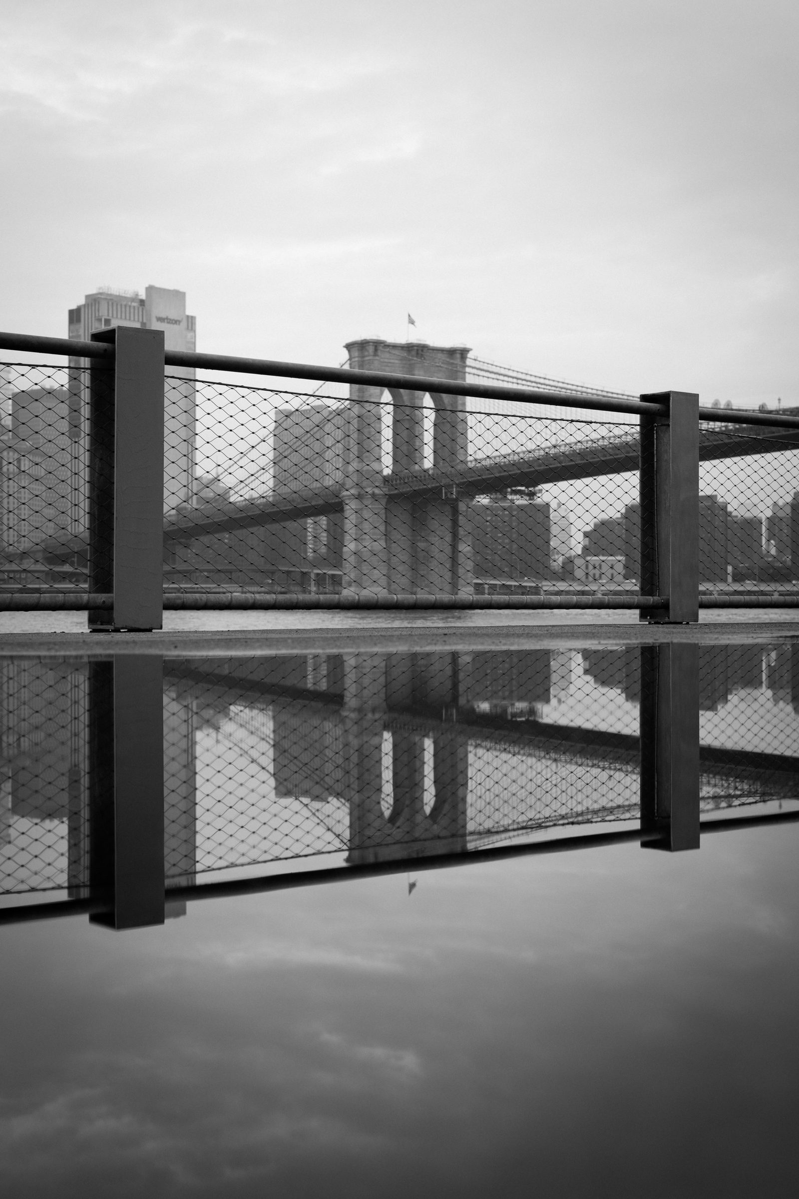Brooklyn Bridge reflected in a puddle