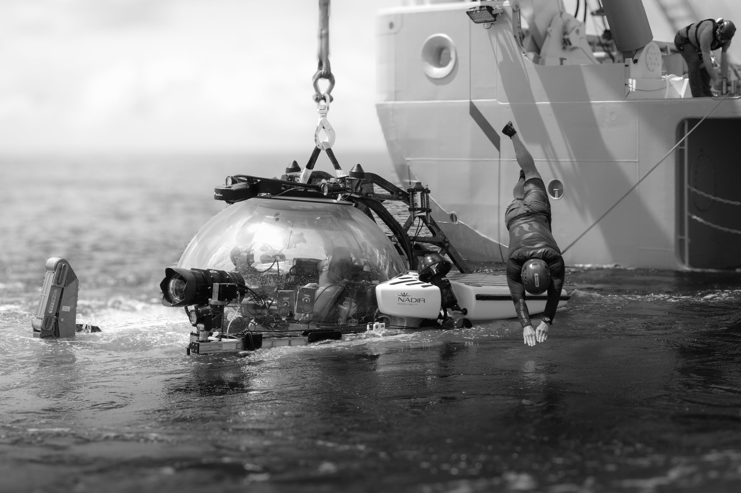 Crew member diving in beside the submersible NADIR