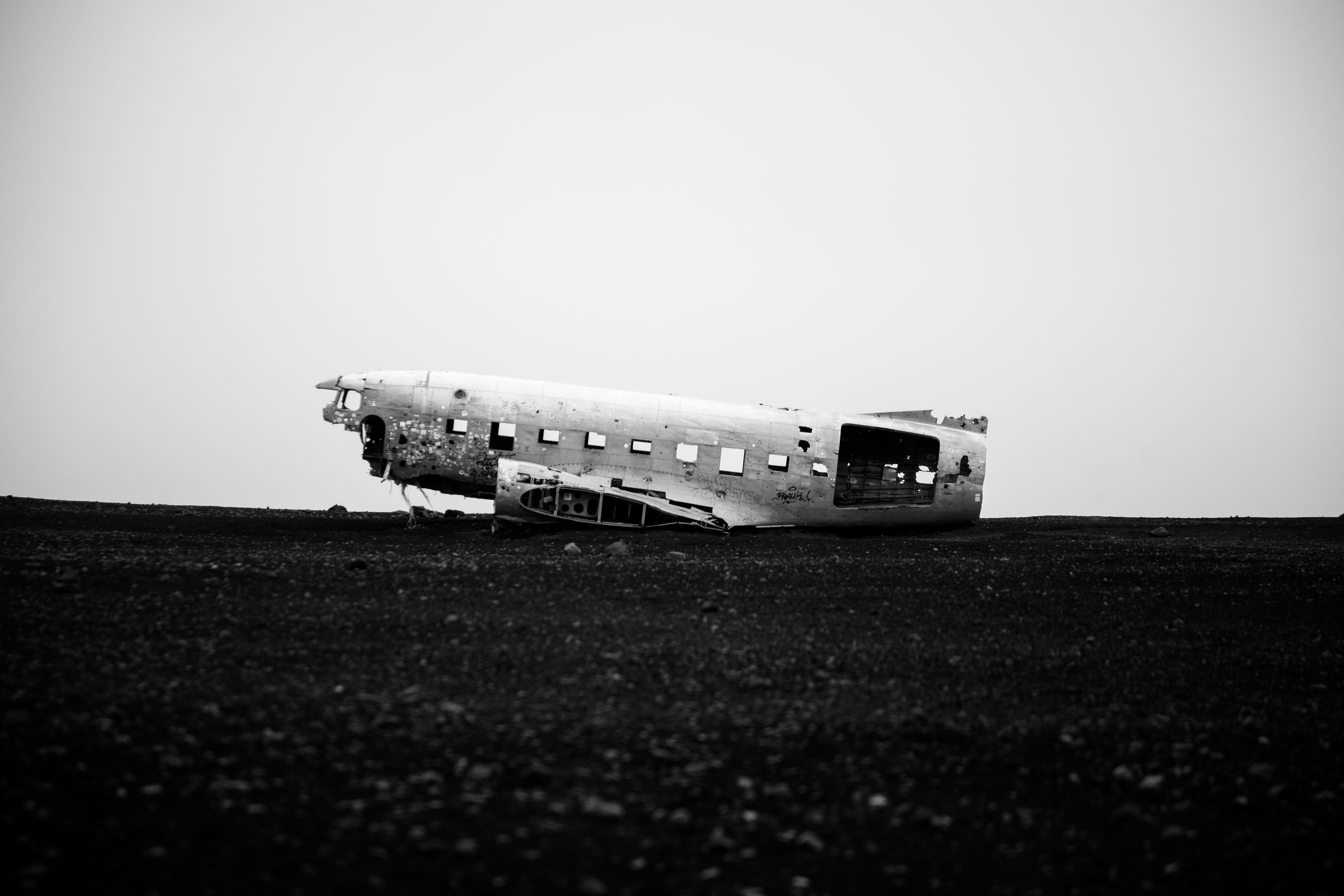 Abandoned DC-3 plane wreck on black sand