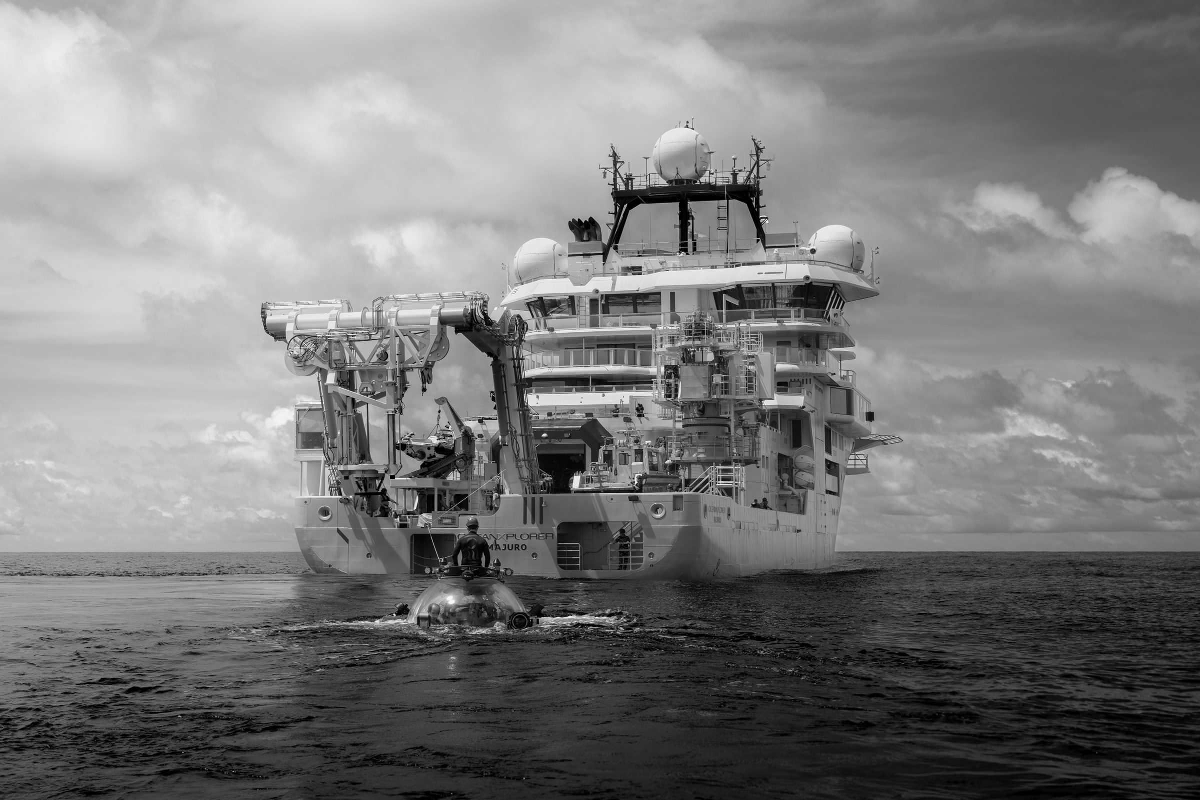 OceanXplorer stern view with submersible and swimmer