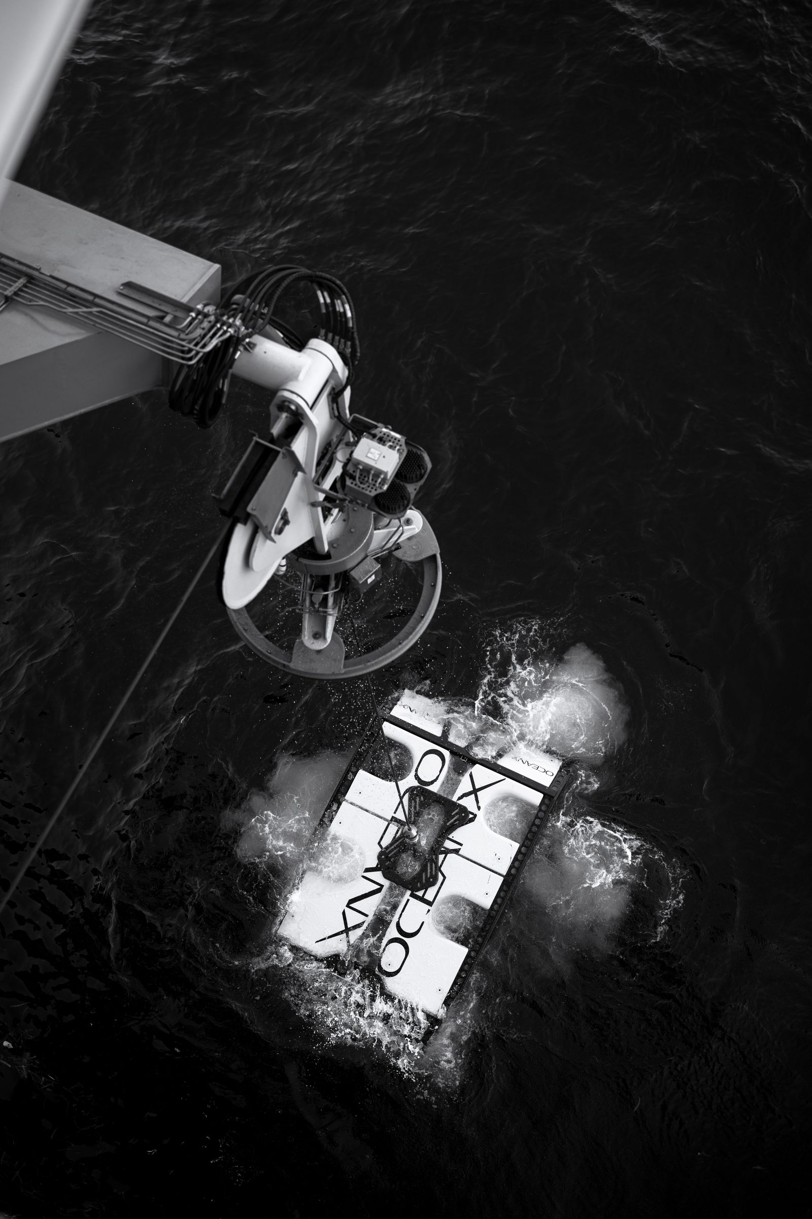 Aerial view of a submersible being lowered into the water